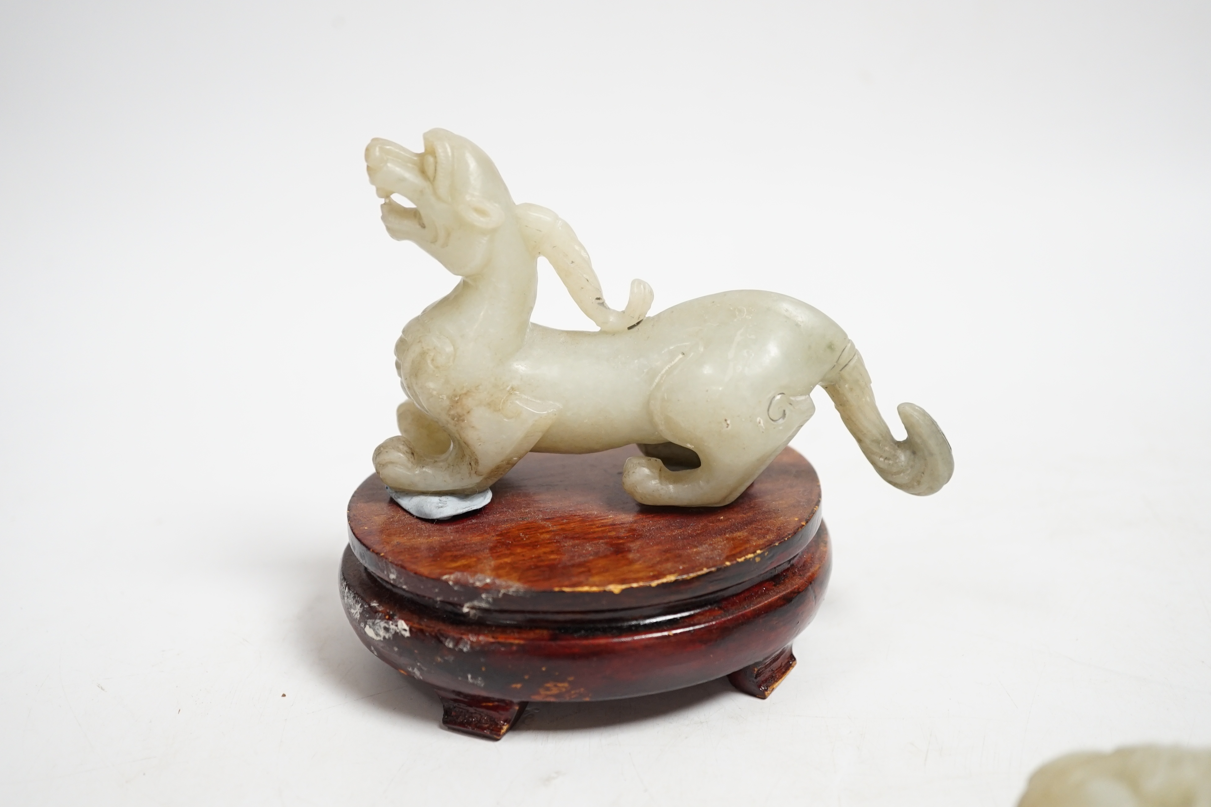 A Chinese pale celadon and grey jade mythical beast on stand, and a pale celadon jade belt hook, mythical beast 11cm wide